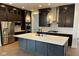 Modern kitchen features dark cabinets, stainless steel appliances, a large island, and stylish pendant lighting at 1225 Amberley Way, Westfield, IN 46074
