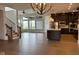 Open-concept living space with hardwood floors, large windows, and a kitchen featuring stainless steel appliances at 1225 Amberley Way, Westfield, IN 46074