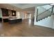 Spacious living room featuring hardwood floors, modern staircase, and an open floor plan leading to the kitchen at 1225 Amberley Way, Westfield, IN 46074