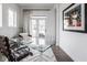 Bright home office with glass desk, modern chair, and outdoor view at 1225 Amberley Way, Westfield, IN 46074