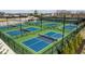 Overhead view of outdoor pickleball courts with green and blue surfaces, surrounded by fencing at 1225 Amberley Way, Westfield, IN 46074