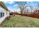 Sprawling backyard, deck, grill, and fenced perimeter create a serene outdoor space at 13 Watson Dr, Trafalgar, IN 46181