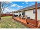 A spacious backyard with a stained wood deck, patio furniture, and a barbecue grill at 13 Watson Dr, Trafalgar, IN 46181