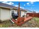 Backyard with wood deck, patio furniture, grill, and string lights for evening enjoyment at 13 Watson Dr, Trafalgar, IN 46181