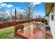 Backyard with a stained wood deck, a table with chairs, and a well-maintained lawn at 13 Watson Dr, Trafalgar, IN 46181