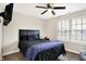 Bedroom featuring a comfortable bed, ceiling fan and large window at 13 Watson Dr, Trafalgar, IN 46181