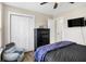 Bedroom with a ceiling fan, closet, a TV, and chair for relaxing at 13 Watson Dr, Trafalgar, IN 46181