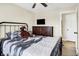 Bedroom with a ceiling fan, TV, natural light, and an en-suite bathroom at 13 Watson Dr, Trafalgar, IN 46181