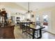 Bright dining area with a farmhouse table and a view of the modern kitchen with stainless steel appliances at 13 Watson Dr, Trafalgar, IN 46181