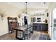Bright dining area with a farmhouse table and views of the modern kitchen and patio at 13 Watson Dr, Trafalgar, IN 46181