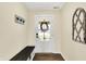 Bright entryway features bench and a decorative coat rack for convenient storage and style at 13 Watson Dr, Trafalgar, IN 46181
