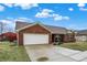 Brick ranch with a two-car garage and concrete driveway at 13 Watson Dr, Trafalgar, IN 46181