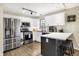 Well-lit kitchen with stainless steel appliances, white cabinets, and a breakfast bar with seating at 13 Watson Dr, Trafalgar, IN 46181