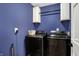 Convenient laundry room featuring a modern black washer and dryer, plus storage cabinets at 13 Watson Dr, Trafalgar, IN 46181