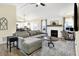 Open-concept living room featuring fireplace and a large sectional at 13 Watson Dr, Trafalgar, IN 46181