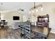 Open-concept living and dining area featuring vaulted ceilings, a ceiling fan, and a comfortable sofa at 13 Watson Dr, Trafalgar, IN 46181
