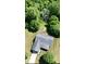 Aerial view of a home nestled in a lush, green wooded lot with mature trees at 130 Hanover Dr, Morristown, IN 46161