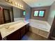 Modern bathroom with double sinks, soaking tub, and vanity with great storage at 130 Hanover Dr, Morristown, IN 46161