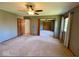 Cozy bedroom with ceiling fan, carpet flooring, and an ensuite bathroom at 130 Hanover Dr, Morristown, IN 46161