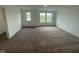 Large bonus room with neutral carpet and a view of the neighborhood at 13610 Grand Abbey Way, Fishers, IN 46037