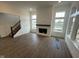 Bright living room with a fireplace, hardwood flooring, and many windows at 13610 Grand Abbey Way, Fishers, IN 46037