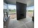 Outdoor fireplace with a brick surround and ample space for seating and entertaining at 13610 Grand Abbey Way, Fishers, IN 46037