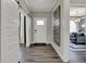 Bright hallway with hardwood floors and an open view to the living room at 13610 Grand Abbey Way, Fishers, IN 46037