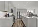 Modern kitchen features stainless steel appliances, ample counter space, and sleek, gray cabinetry at 13610 Grand Abbey Way, Fishers, IN 46037