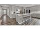 Kitchen island with bar seating, stainless appliances, and lots of storage at 13610 Grand Abbey Way, Fishers, IN 46037