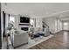 Light-filled living room with modern decor, a fireplace, and an open floor plan at 13610 Grand Abbey Way, Fishers, IN 46037