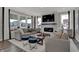 Sun-filled living room features a sleek fireplace and comfortable, modern furnishings at 13610 Grand Abbey Way, Fishers, IN 46037