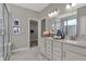 Elegant main bathroom features double vanity, marble floors, large mirror and spacious glass enclosed shower at 13610 Grand Abbey Way, Fishers, IN 46037