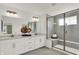The stunning bathroom features a double vanity, a large shower, and modern fixtures at 13622 Grand Abbey Way, Fishers, IN 46037