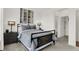 Comfortable bedroom with a metal frame bed, side tables, and neutral color scheme at 13622 Grand Abbey Way, Fishers, IN 46037