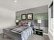 Cozy bedroom with gray walls, plaid bedding, and baseball-themed decor for a sporty and stylish look at 13622 Grand Abbey Way, Fishers, IN 46037