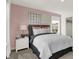 Bedroom with stylish decor, a grey upholstered headboard and large windows at 13622 Grand Abbey Way, Fishers, IN 46037