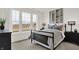 Cozy bedroom with shiplap accent wall, three windows, and neutral decor at 13622 Grand Abbey Way, Fishers, IN 46037