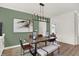 Dining room with modern chandelier, decorative wall art, and seating for six at 13622 Grand Abbey Way, Fishers, IN 46037