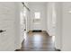 Bright entryway with hardwood floors, white walls, and a view through the glass front door at 13622 Grand Abbey Way, Fishers, IN 46037