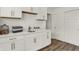 Well-lit laundry room featuring white cabinets, a sink, a sleek faucet and sliding closet doors at 13622 Grand Abbey Way, Fishers, IN 46037