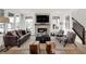 Bright living room with fireplace, tv, staircase, large windows, sofa, and stylish decor at 13622 Grand Abbey Way, Fishers, IN 46037