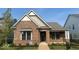 Charming single-story brick home with manicured lawn and inviting walkway leading to the front door at 13634 Grand Abbey Way, Fishers, IN 46037