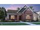 Charming brick home with a well-manicured lawn and professional landscaping at 13634 Grand Abbey Way, Fishers, IN 46037