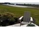 Serene backyard patio with outdoor seating and landscaped garden view overlooking a pond with fountains at 1366 Foxtail Ln, Greenwood, IN 46143
