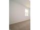 This bedroom is bright and airy with neutral carpeting and base molding at 1366 Foxtail Ln, Greenwood, IN 46143