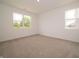 Bright, carpeted bedroom with two large windows offering natural light at 1366 Foxtail Ln, Greenwood, IN 46143