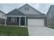 Charming single-Gathering home featuring a two-car garage and a welcoming, covered front porch at 1366 Foxtail Ln, Greenwood, IN 46143