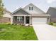 Charming single-Gathering home with manicured lawn, brick accents, and a two-car garage in a suburban neighborhood at 1366 Foxtail Ln, Greenwood, IN 46143