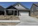 New construction home featuring a brick facade, attached two-car garage, and a concrete driveway at 1366 Foxtail Ln, Greenwood, IN 46143