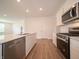 Modern kitchen with stainless steel appliances, white cabinets, and a spacious center island at 1366 Foxtail Ln, Greenwood, IN 46143